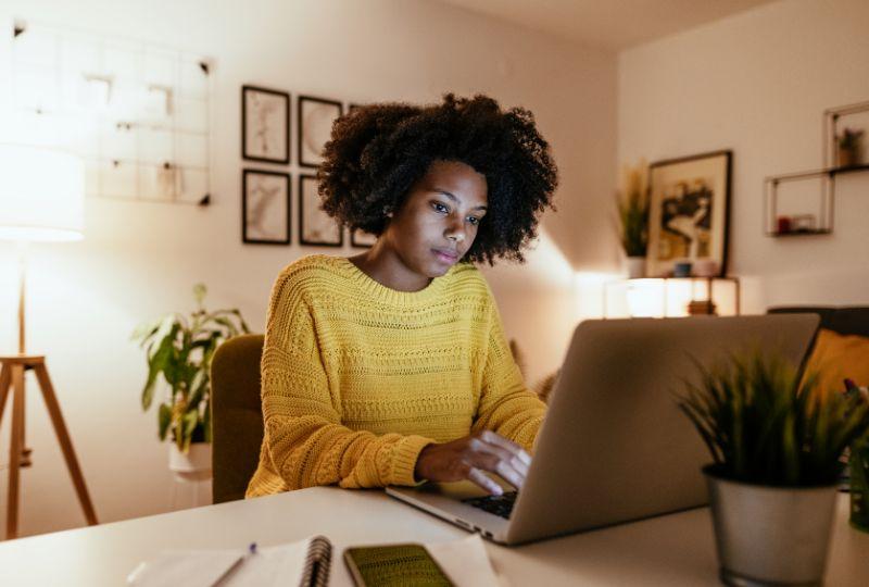 Young Black woman seeks mental health care online at mymindhelp.com.